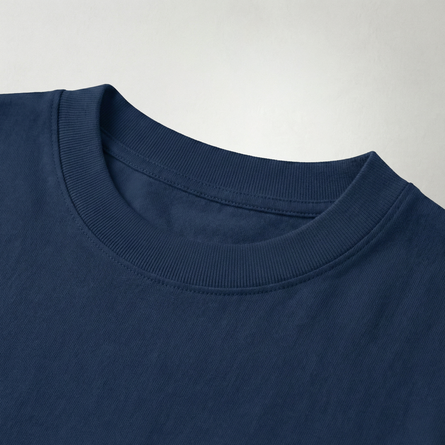 Close-up of navy blue oversized t-shirt ribbed cotton neckline