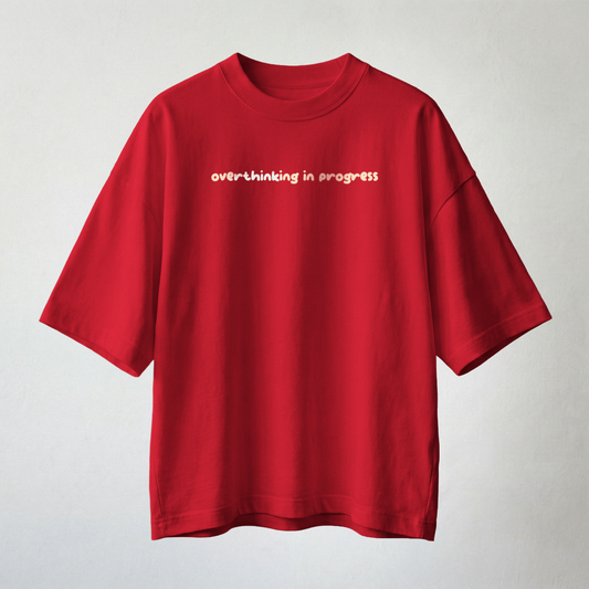 Red oversized t-shirt with “overthinking in progress” text minimal aesthetic