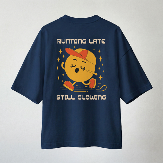 Navy blue oversized t-shirt with “Running Late Still Glowing” cartoon back print