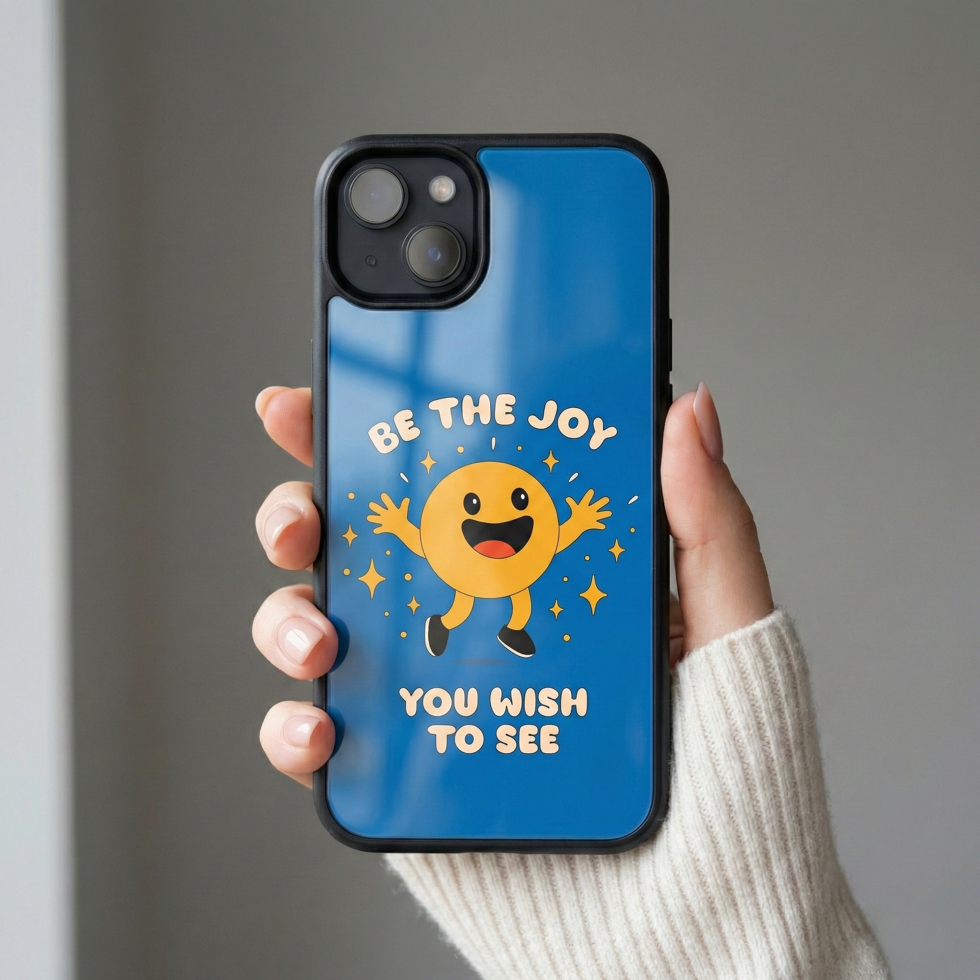 Person holding Be The Joy You Wish To See glass iPhone case in natural light
