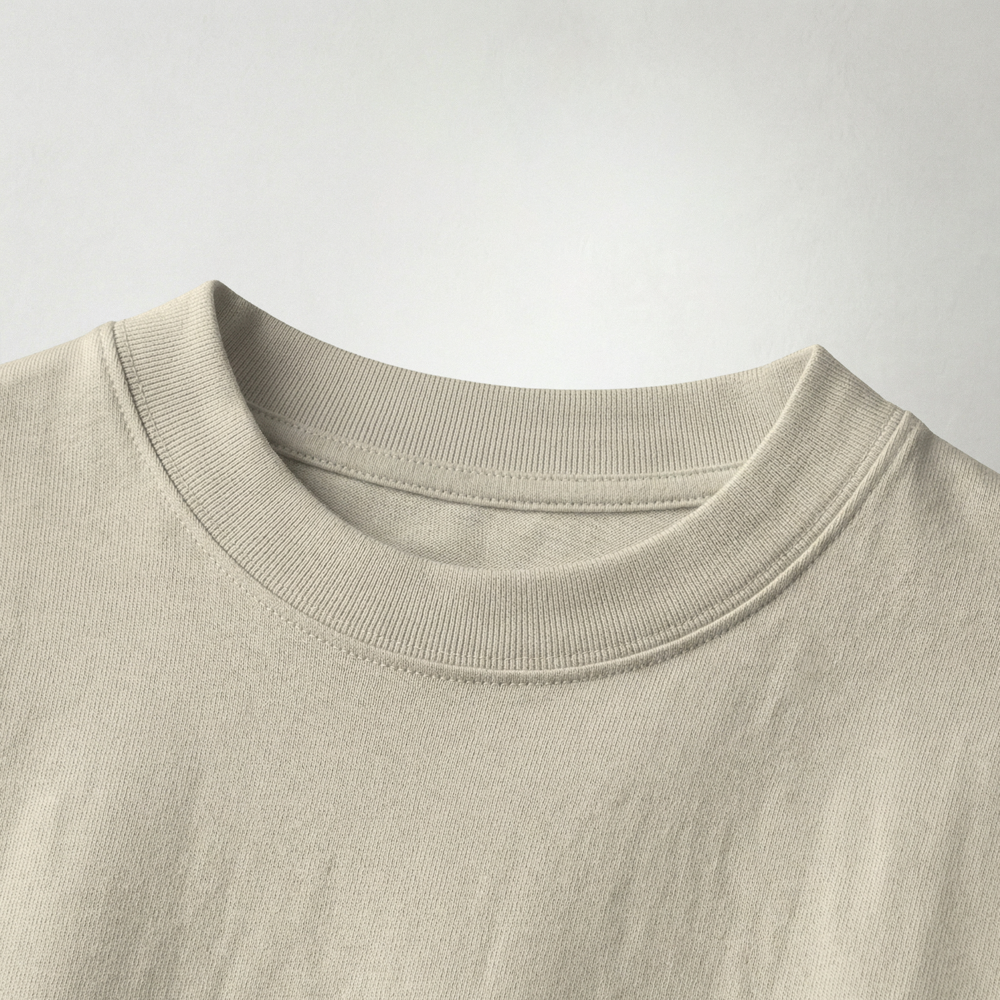Close-up of beige oversized t-shirt collar fabric texture premium cotton