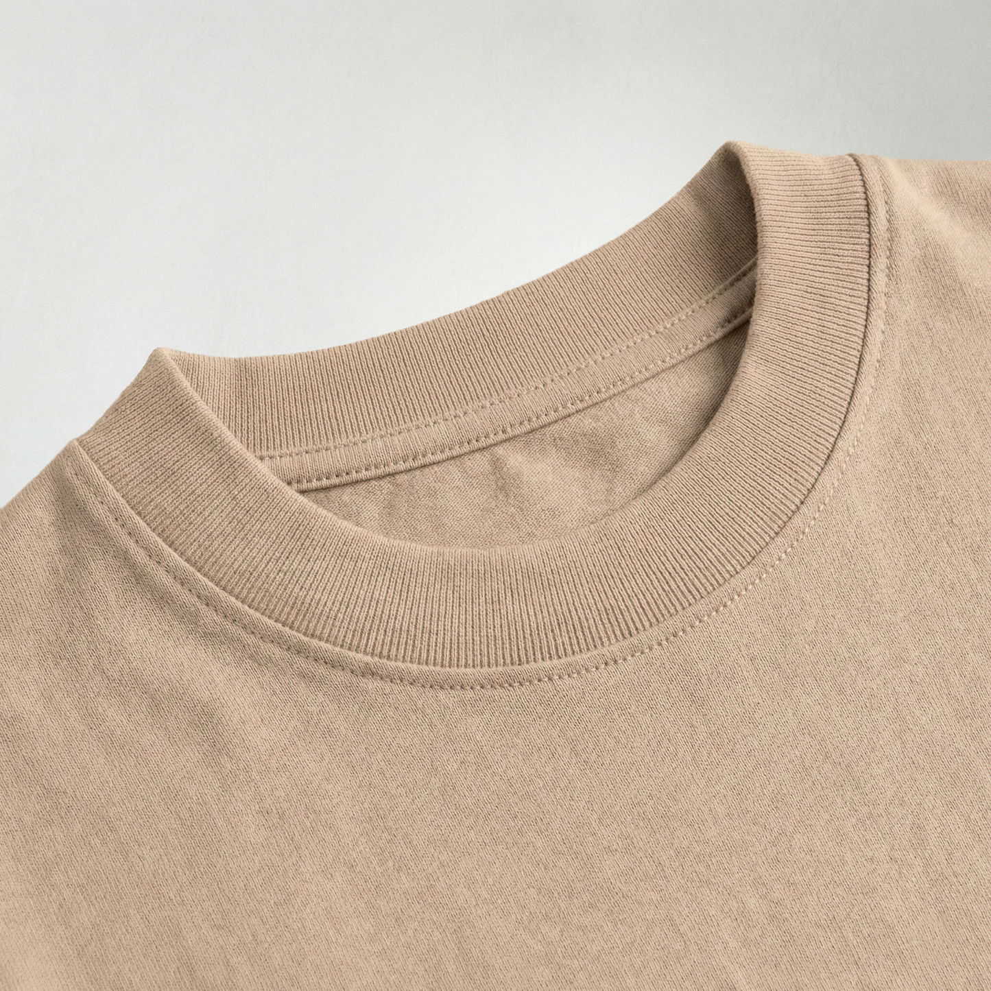 Close-up of beige oversized t-shirt ribbed cotton neckline