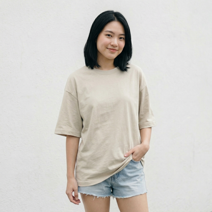Woman wearing beige oversized t-shirt front view oversized relaxed minimal look