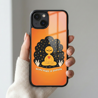 Close up of Being Here Is Enough premium orange glass iPhone case with glossy back finish