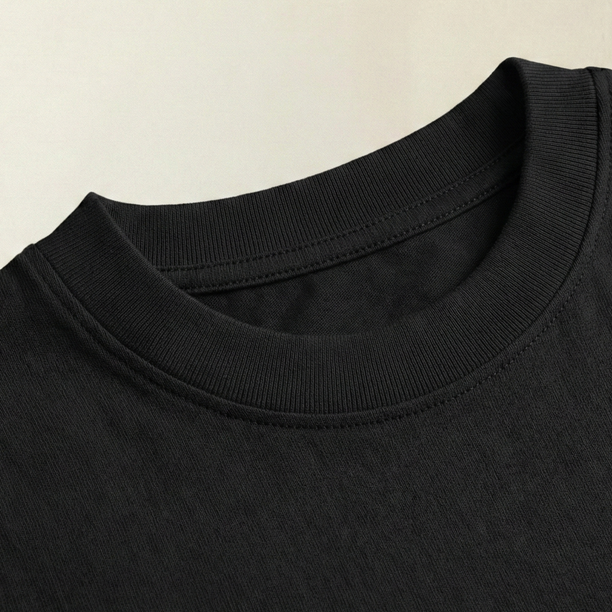 Close-up of black oversized t-shirt ribbed cotton neckline