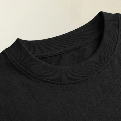 Close-up of black oversized t-shirt ribbed cotton neckline
