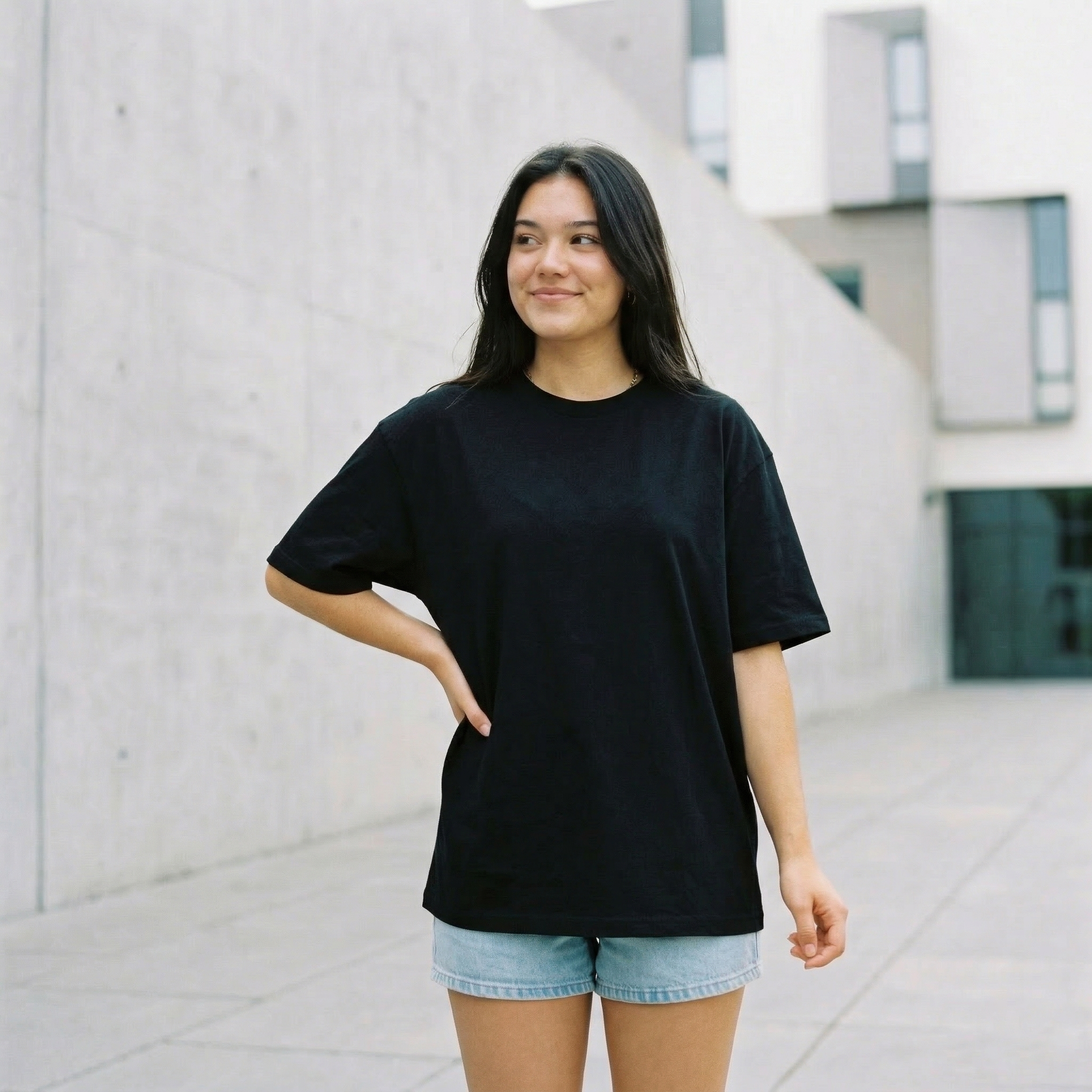 Woman wearing black oversized t-shirt front view relaxed fit minimal casual look