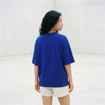 Back view of blue oversized t-shirt worn by woman showing relaxed fit