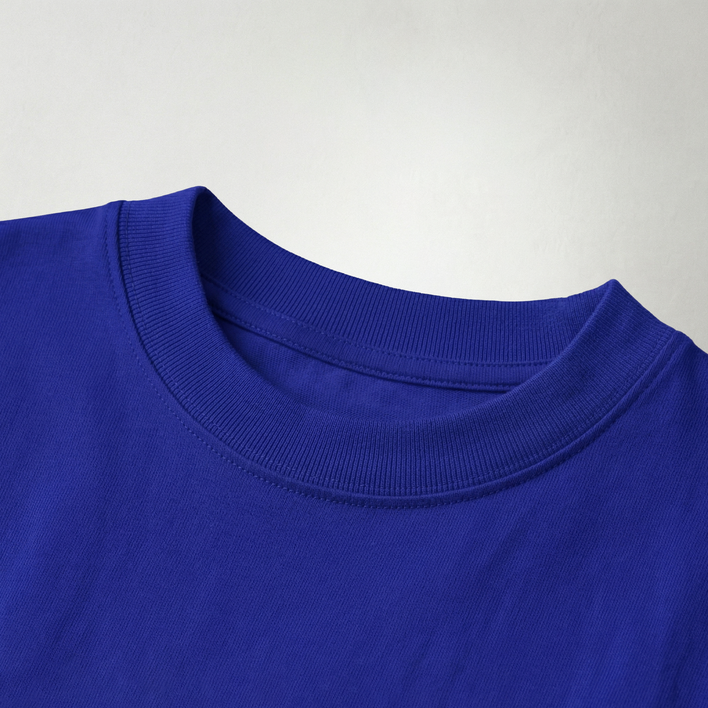 Close-up of blue oversized t-shirt fabric texture and neckline detail