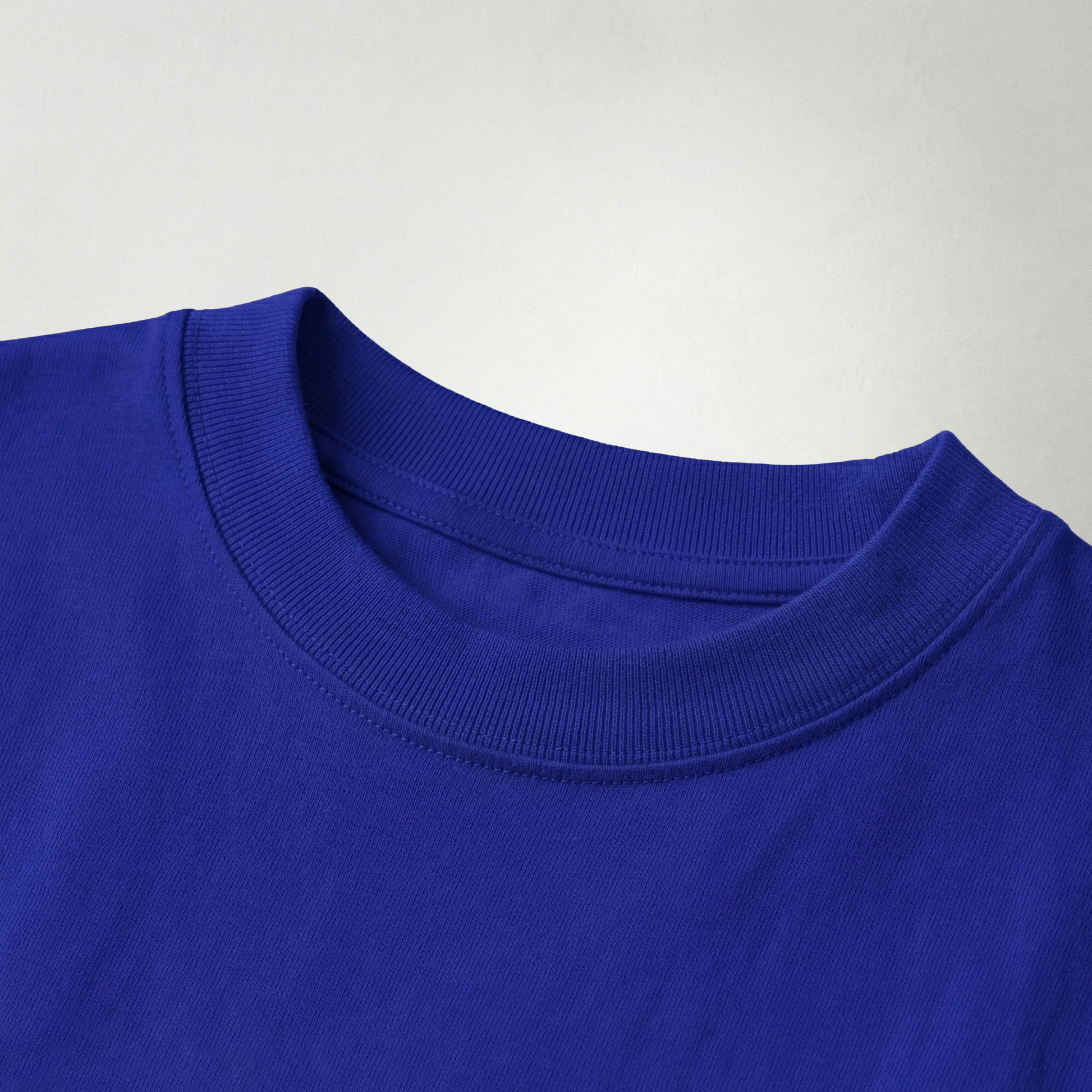 Close-up of blue oversized t-shirt fabric texture and neckline detail