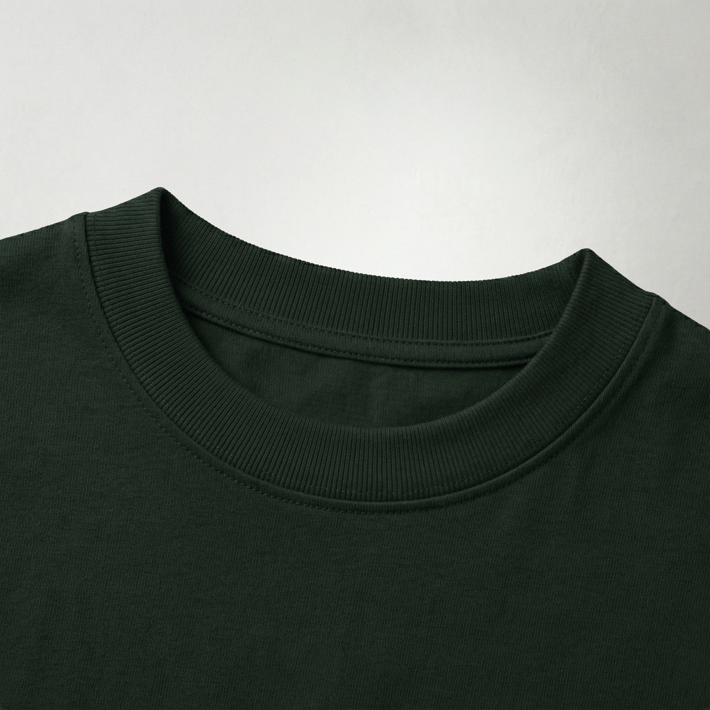 Close-up of dark green oversized t-shirt collar texture premium cotton fabric