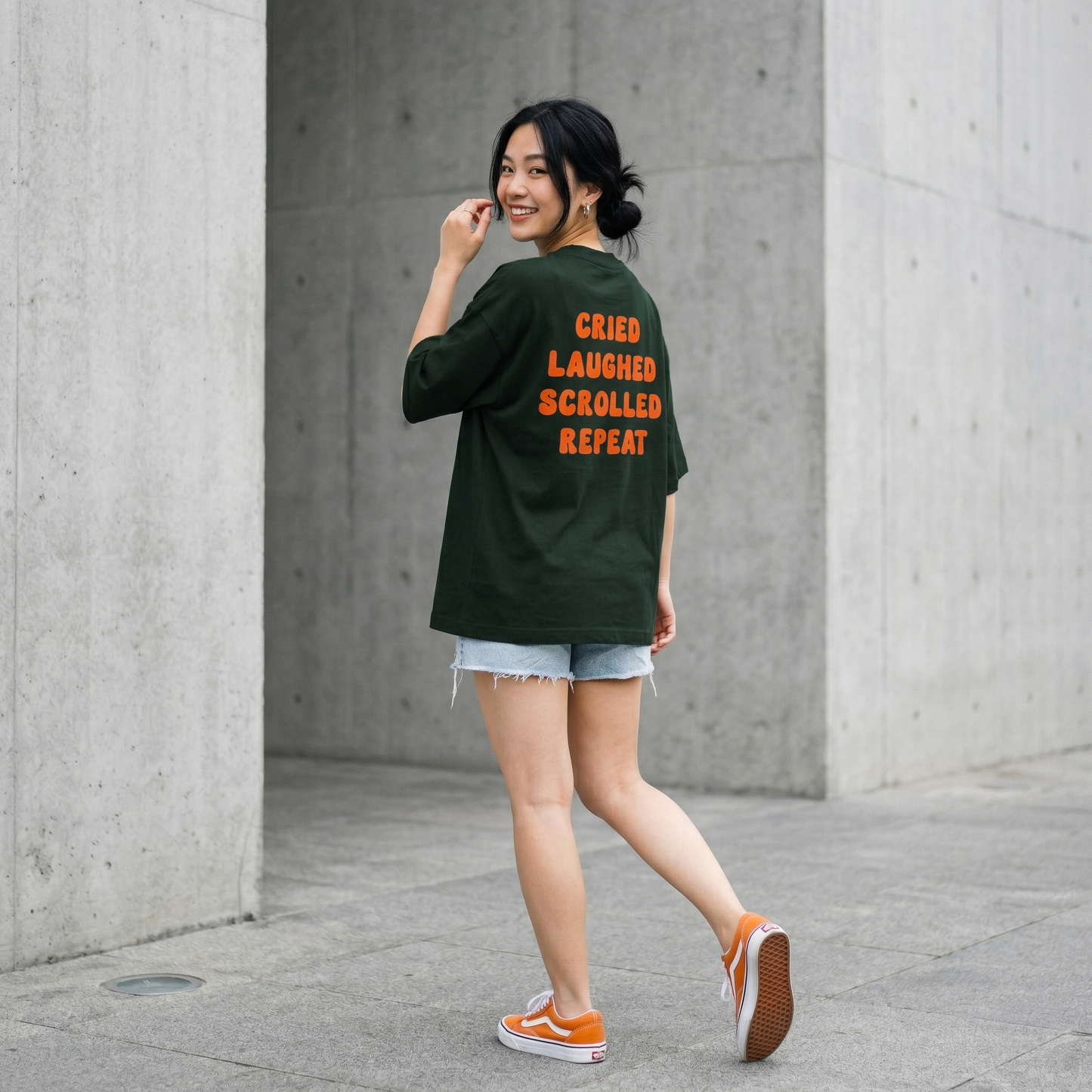 Woman walking in oversized green t-shirt with emotional text back casual aesthetic