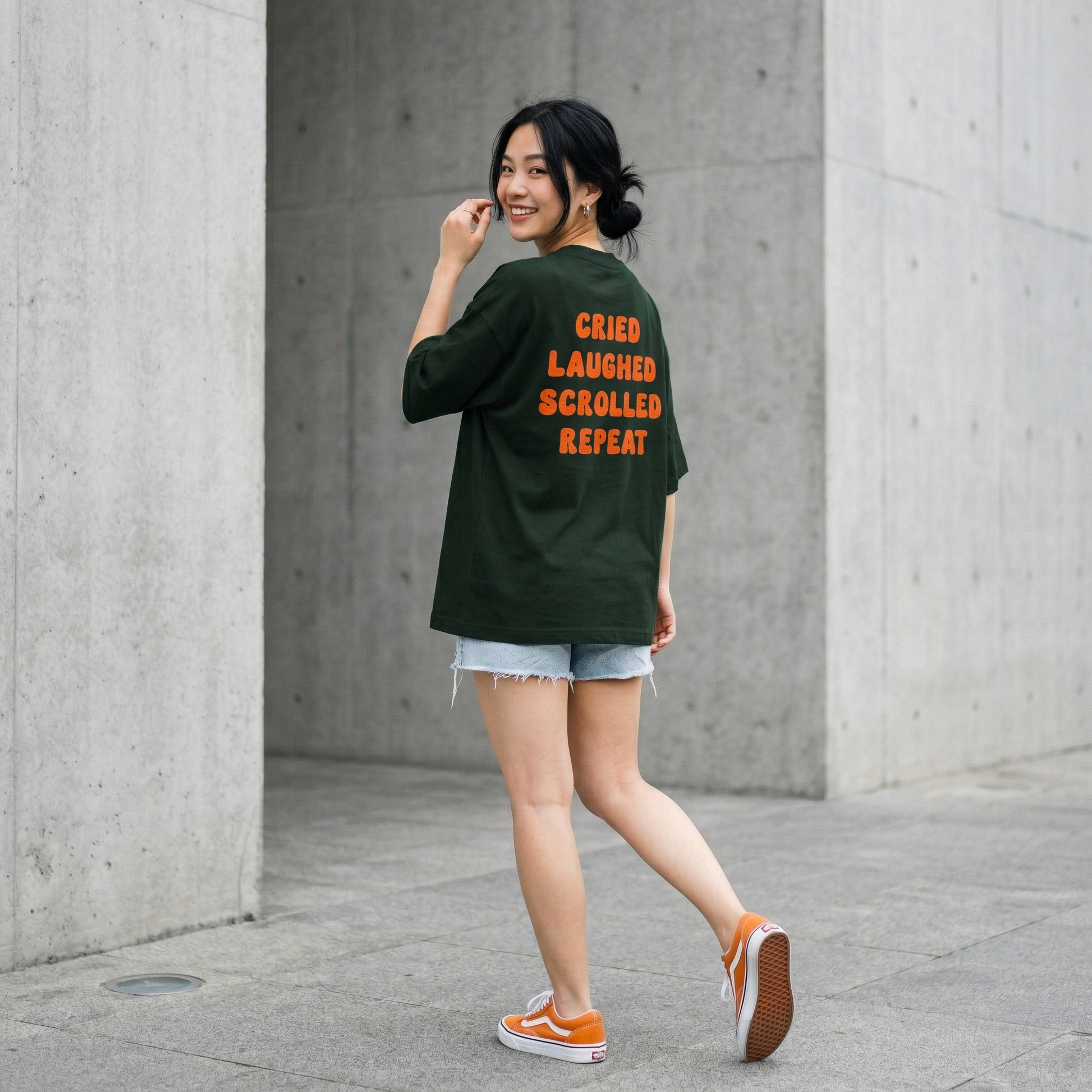 Woman walking in oversized green t-shirt with emotional text back casual aesthetic