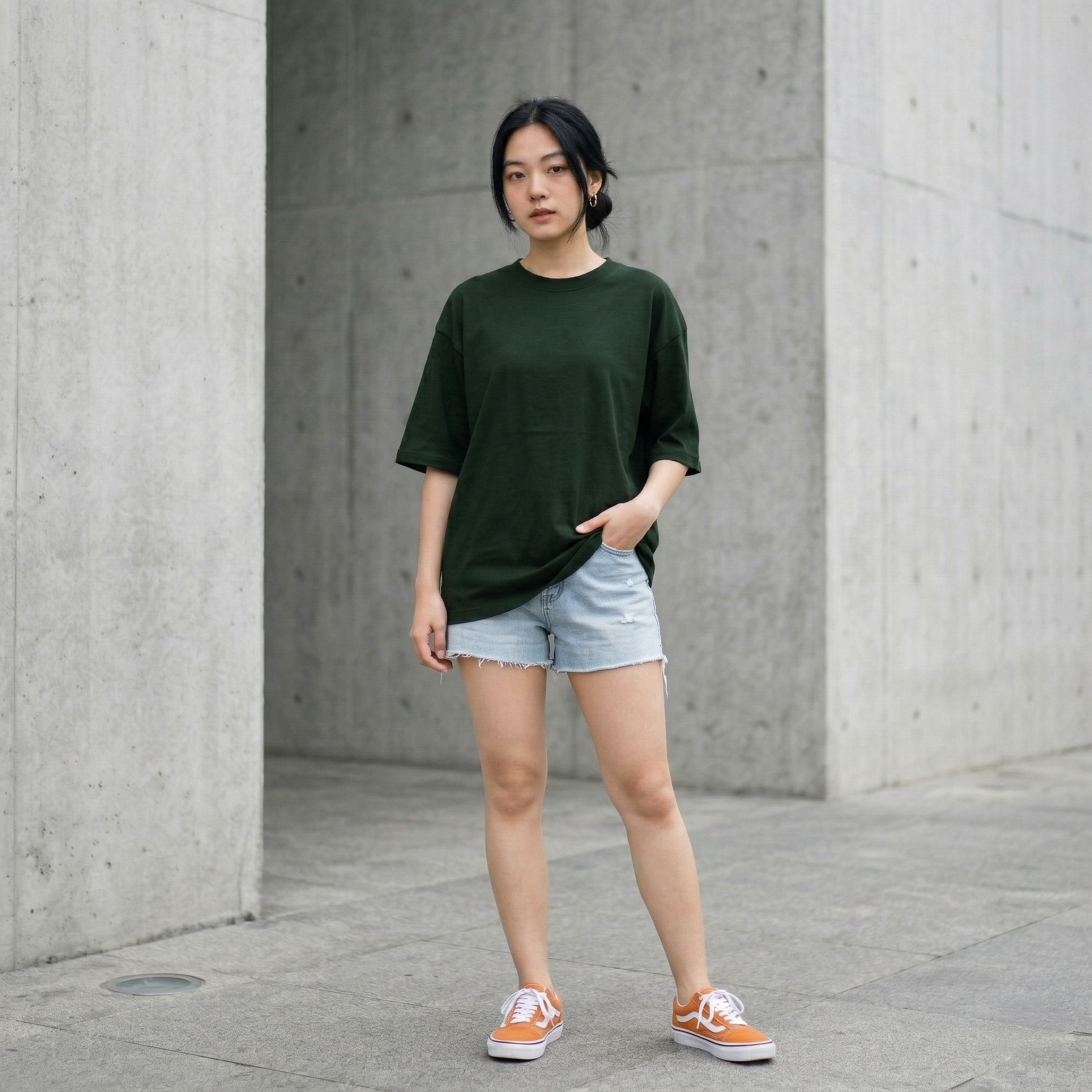 Woman wearing dark green oversized t-shirt front view relaxed fit minimal style