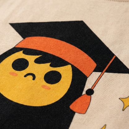 Close-up of graduation character print on beige oversized t-shirt