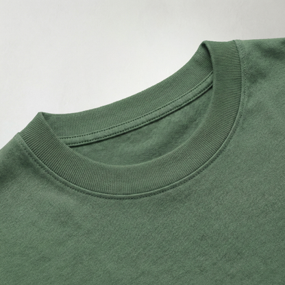 Close up of green oversized cotton t-shirt neckline and fabric texture detail