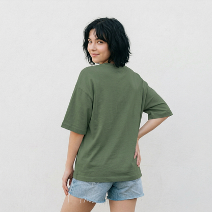 Woman wearing green oversized t-shirt back view relaxed fit casual aesthetic