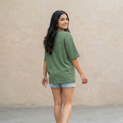 Woman wearing green oversized t-shirt back view relaxed fit casual lifestyle
