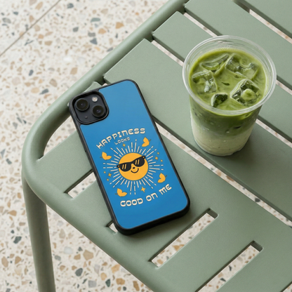 Happiness Looks Good On Me blue glass iPhone case by Spiritual Kalakaar placed on cafe table beside iced matcha drink