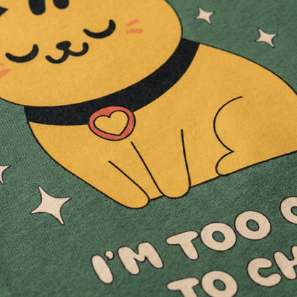 Close-up of cute yellow cat graphic print on sage green oversized t-shirt