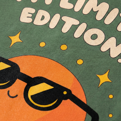 Close-up of orange character with sunglasses print on green oversized t-shirt
