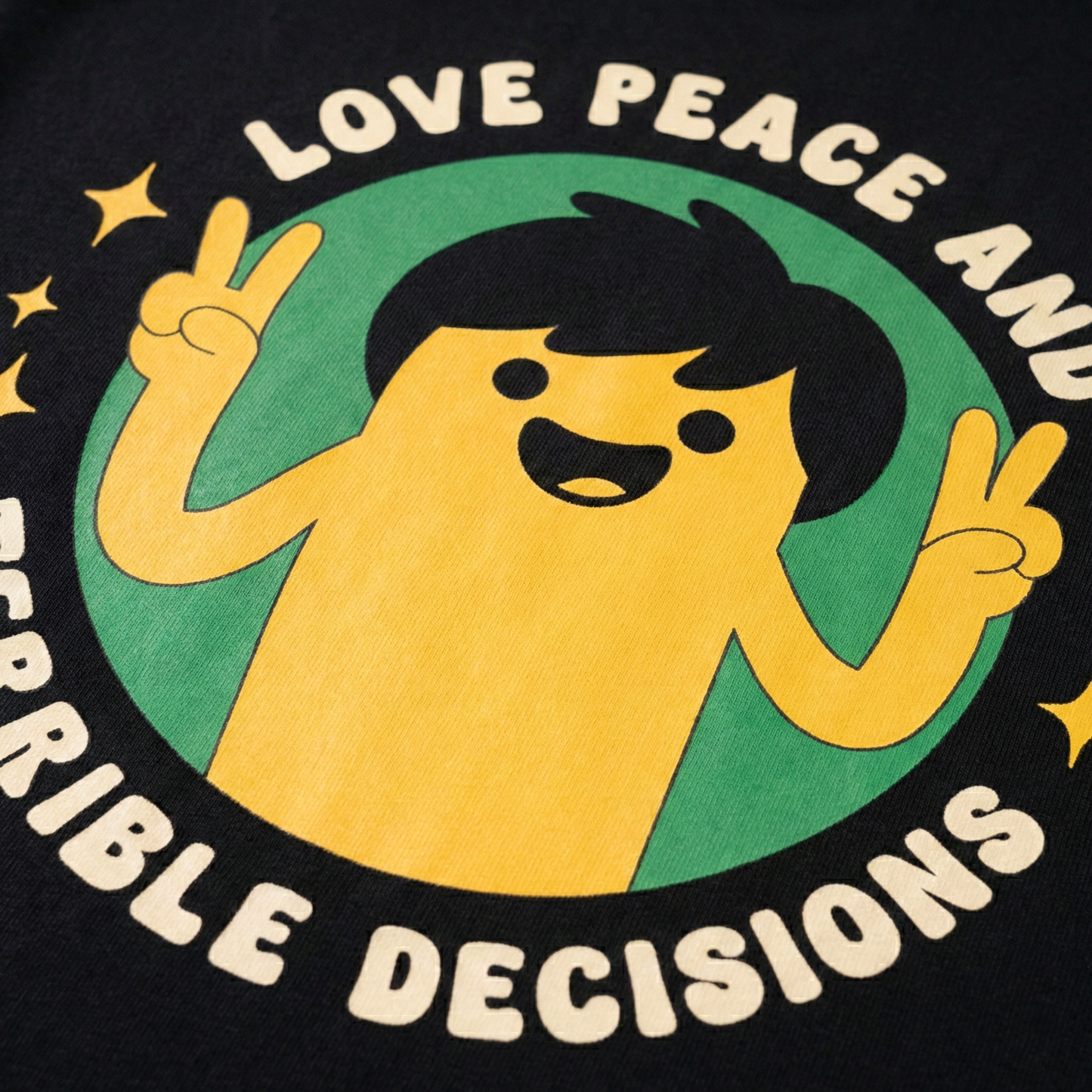Close-up of cartoon peace sign character print on black oversized t-shirt