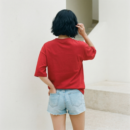 Back view of red oversized t-shirt worn by woman showing relaxed fit