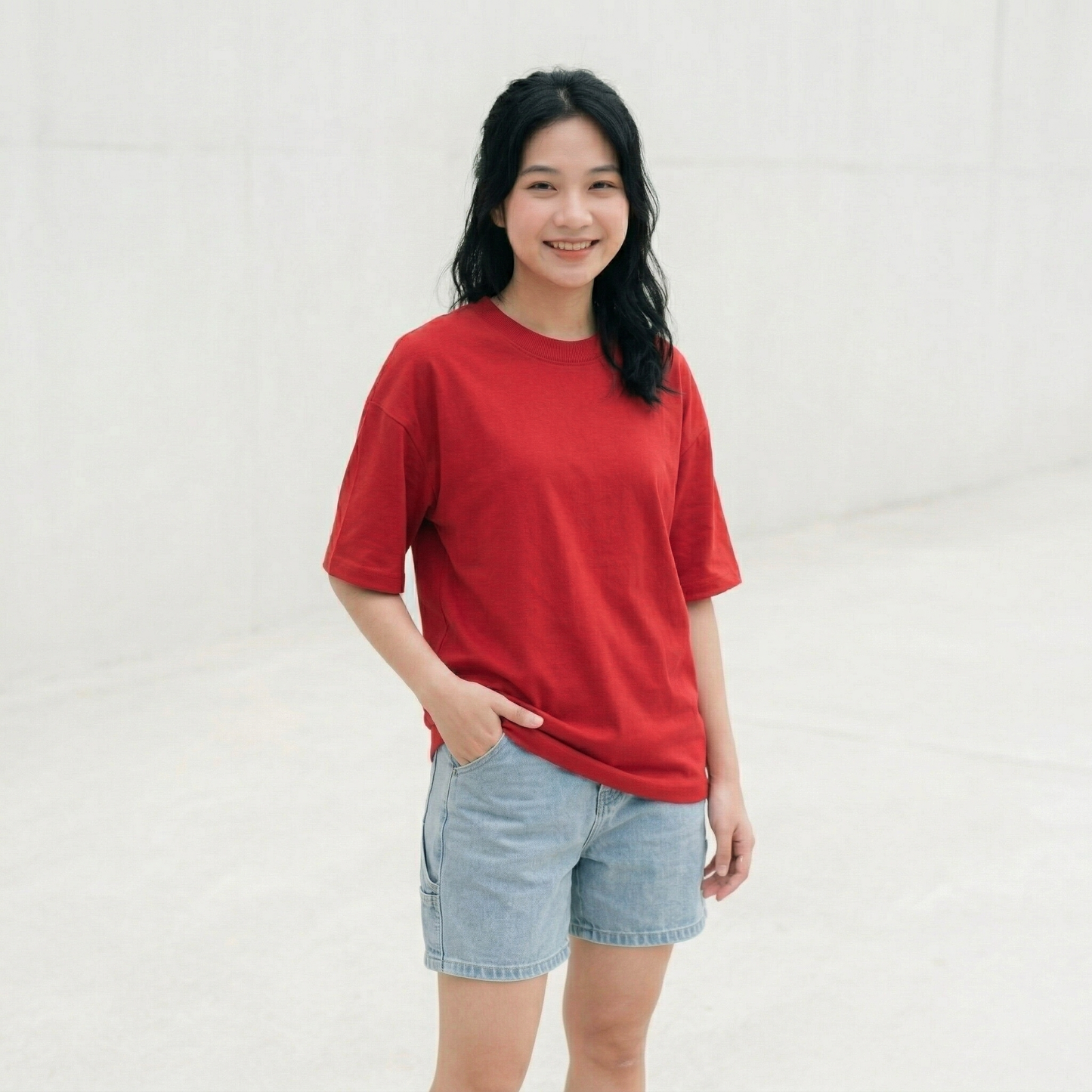 Woman wearing red oversized t-shirt front view relaxed fit minimal casual style