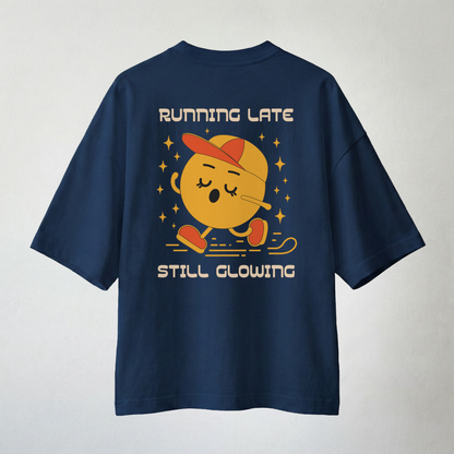 Navy blue oversized t-shirt with “Running Late Still Glowing” cartoon back print